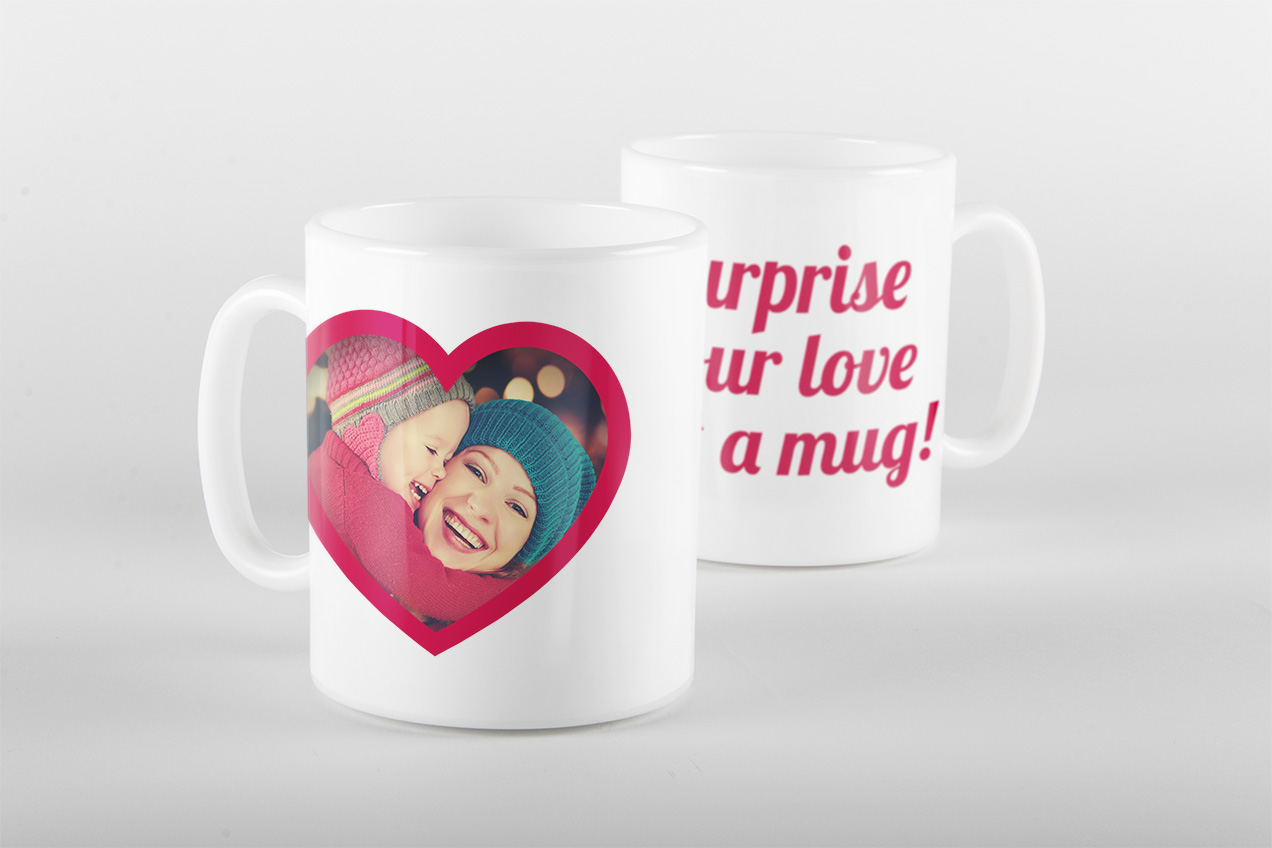 Two white photo mugs, one with a heart-shaped photo frame of two children, the other reading 'Surprise your love with a mug!'