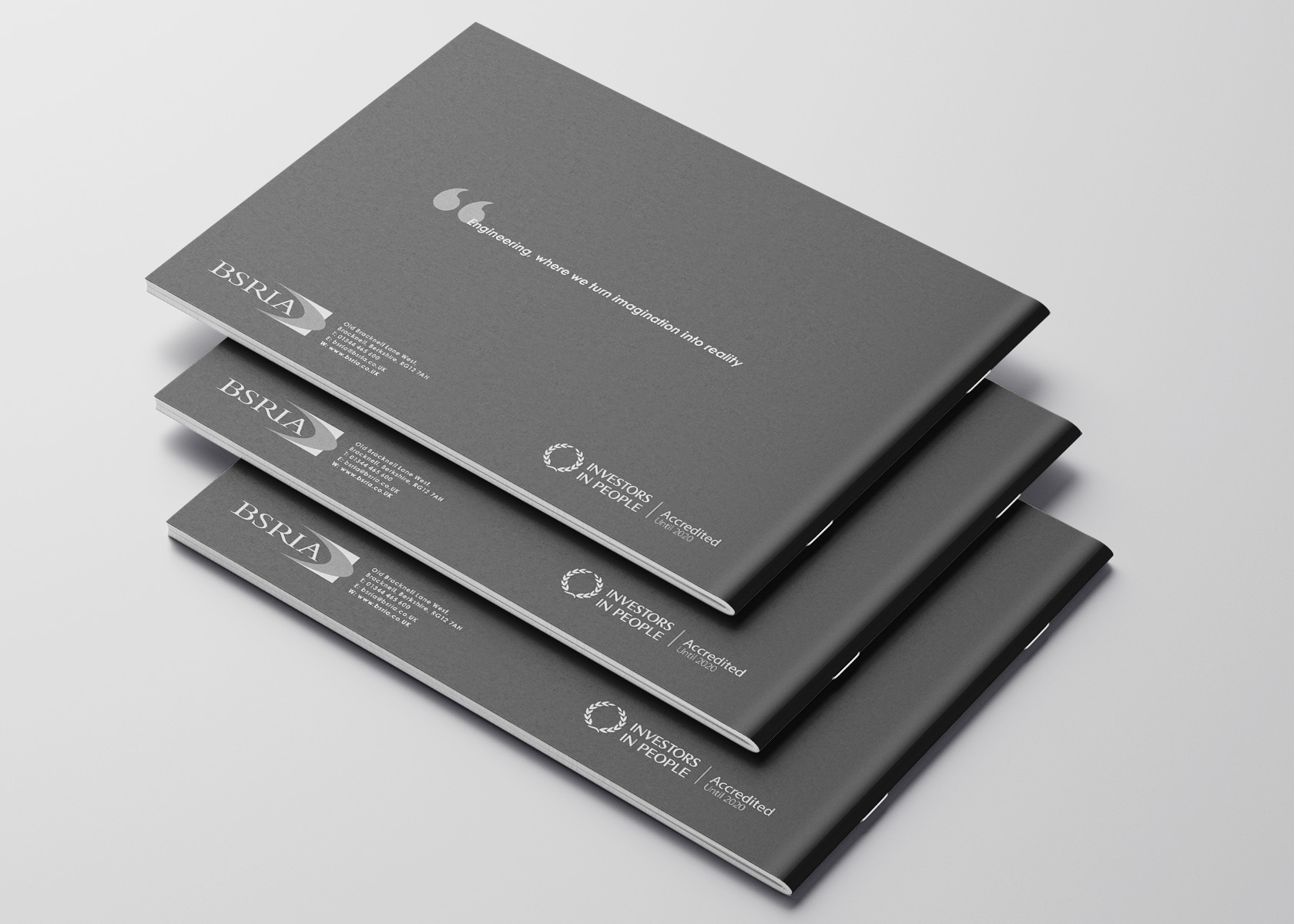 Stack of Inspire brochures showing the grey back cover