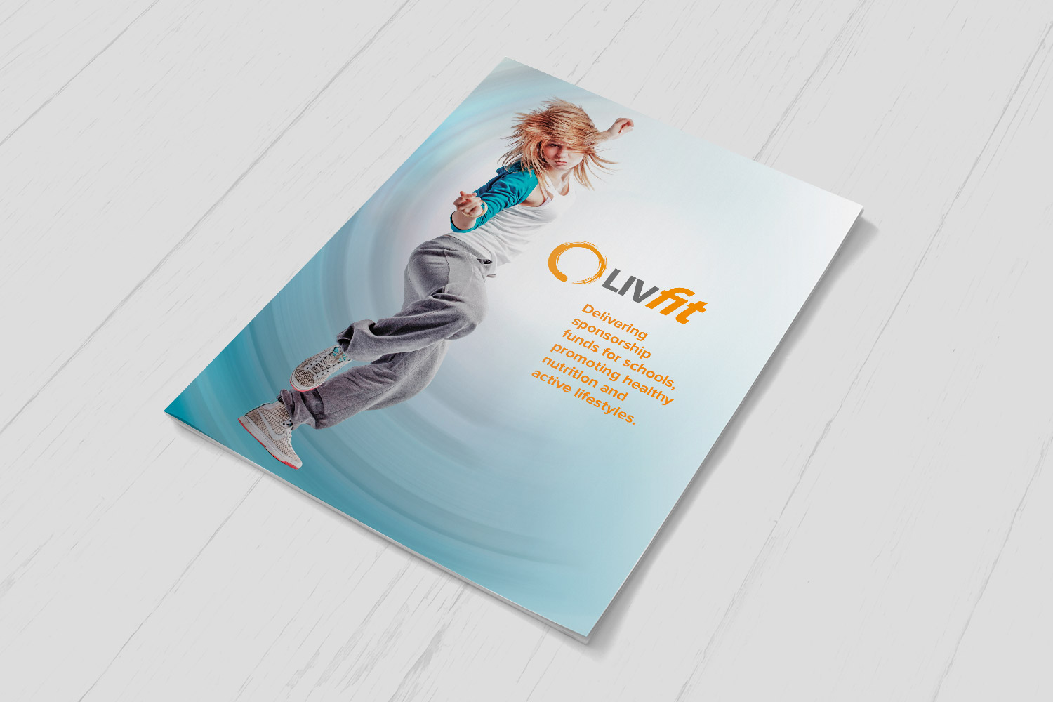 Cover of the LivFit sponsorship brochure, which raises funds for sport and healthy eating in schools: a young dancer leaping against a teal background