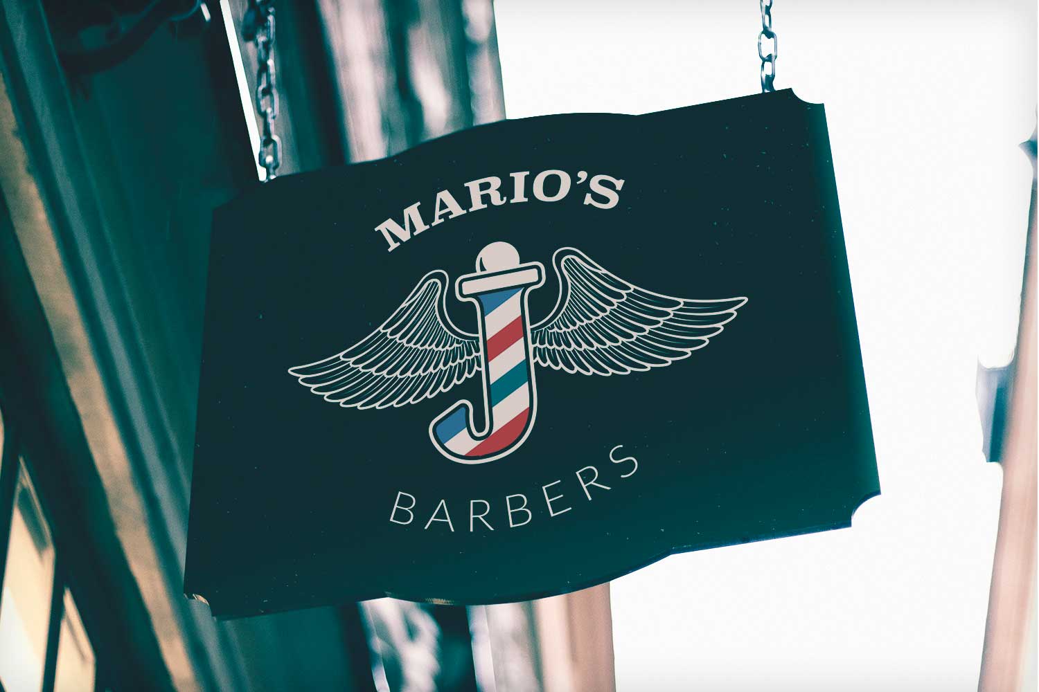 Mario's Barbers hanging shop sign in dark teal with a winged barber's pole emblem