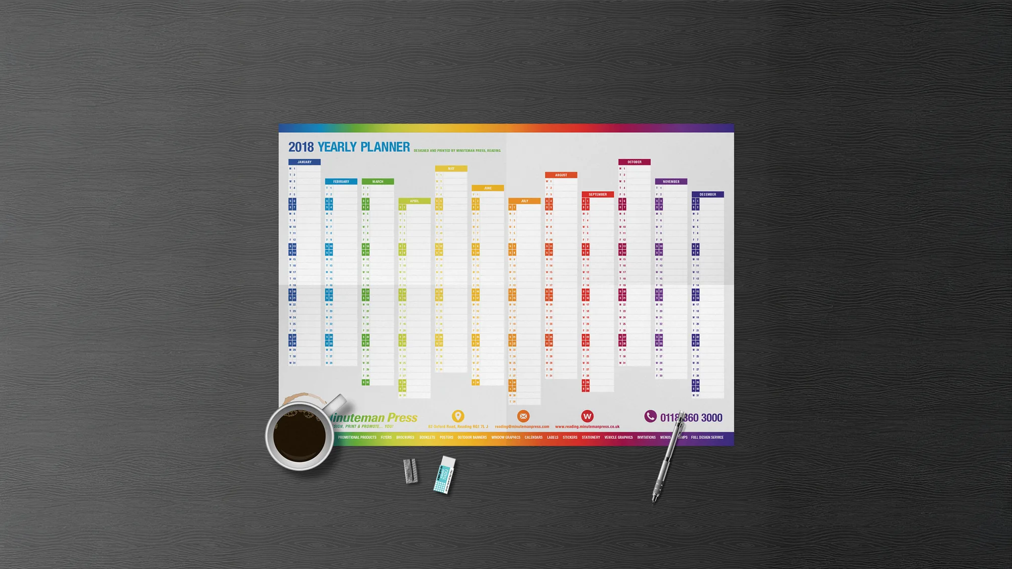 Colour-coded yearly wall planner on a desk