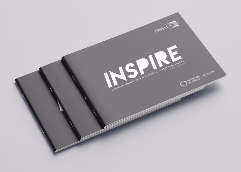 Stack of Inspire brochures with a grey cover and the white title 'INSPIRE'
