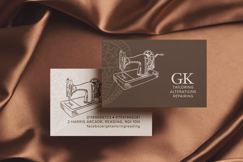 GK Tailoring and Alterations business cards with a vintage sewing machine illustration, on brown silk