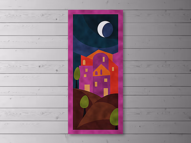 Tall velvet patchwork wall hanging of a night scene: a crescent moon over a house with lit windows, in purple and orange with a magenta border