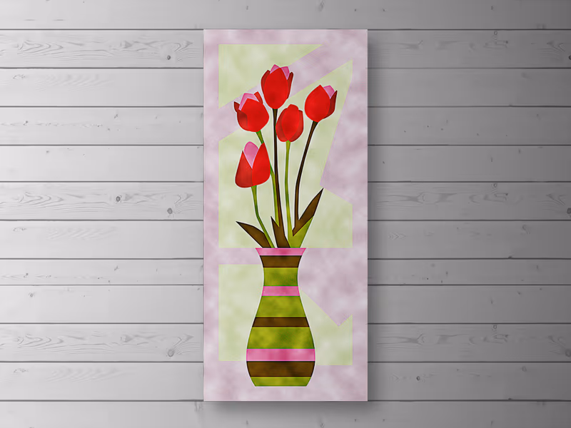 Tall velvet patchwork wall hanging of red tulips in a striped vase, on a white wooden wall