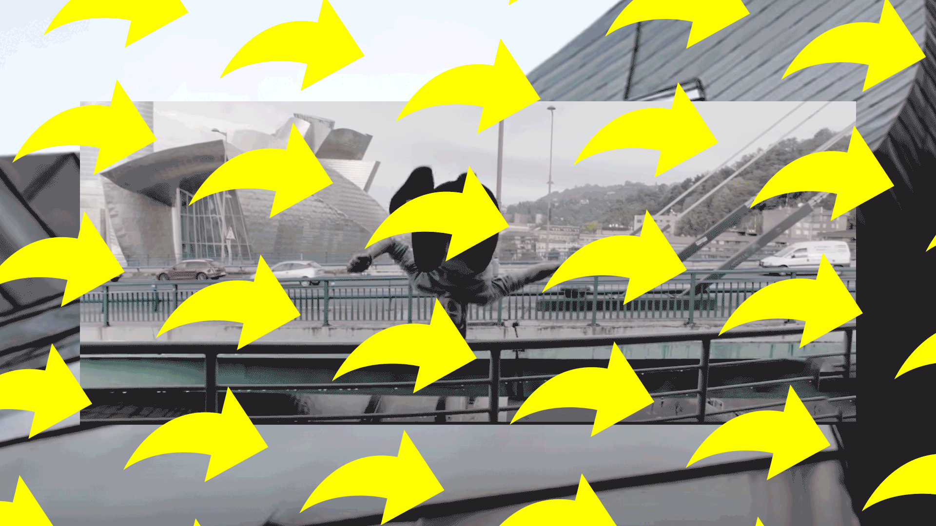 Person performing a backflip on a railing near a distinctive modern building and a bridge with cars in the background.