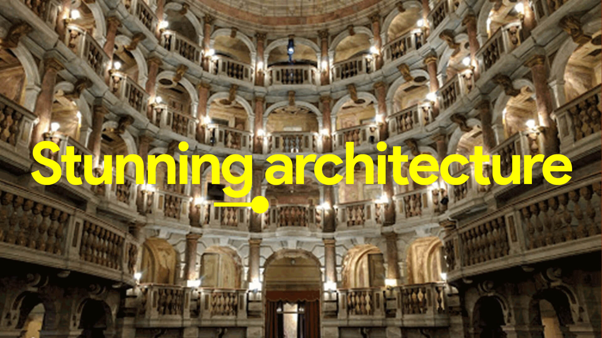 Interior view of a grand, multi-tiered historic theater with ornate balconies and warm lighting.