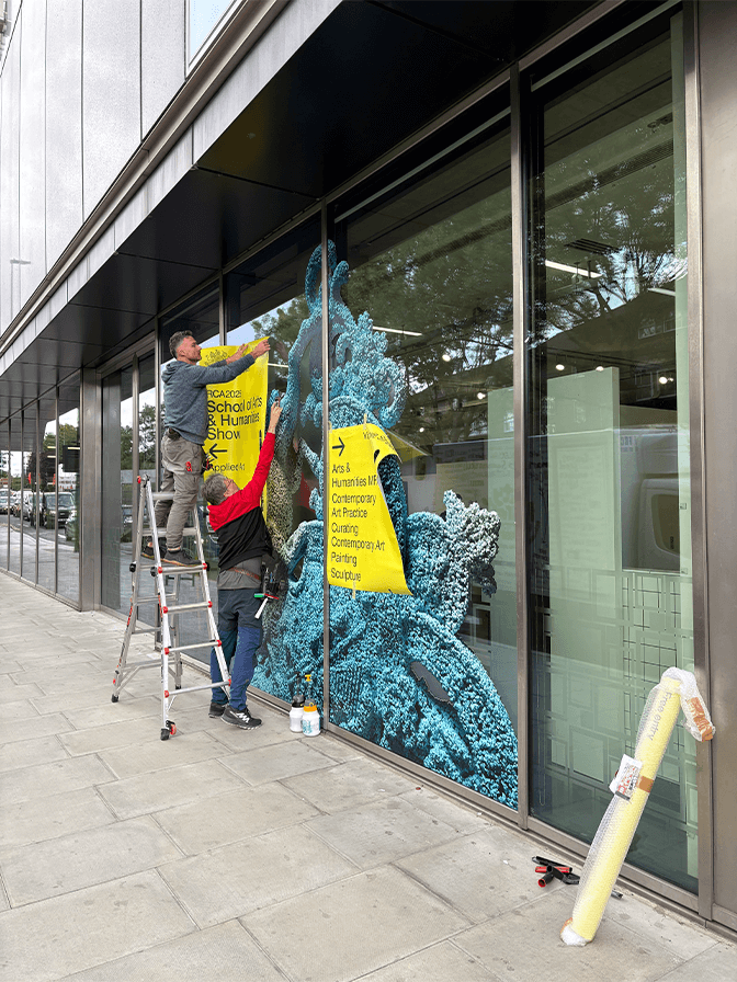 Smartphone displaying Vermeer's painting 'Girl with a Pearl Earring' with the text 'Meet Vermeer' over a blue background.