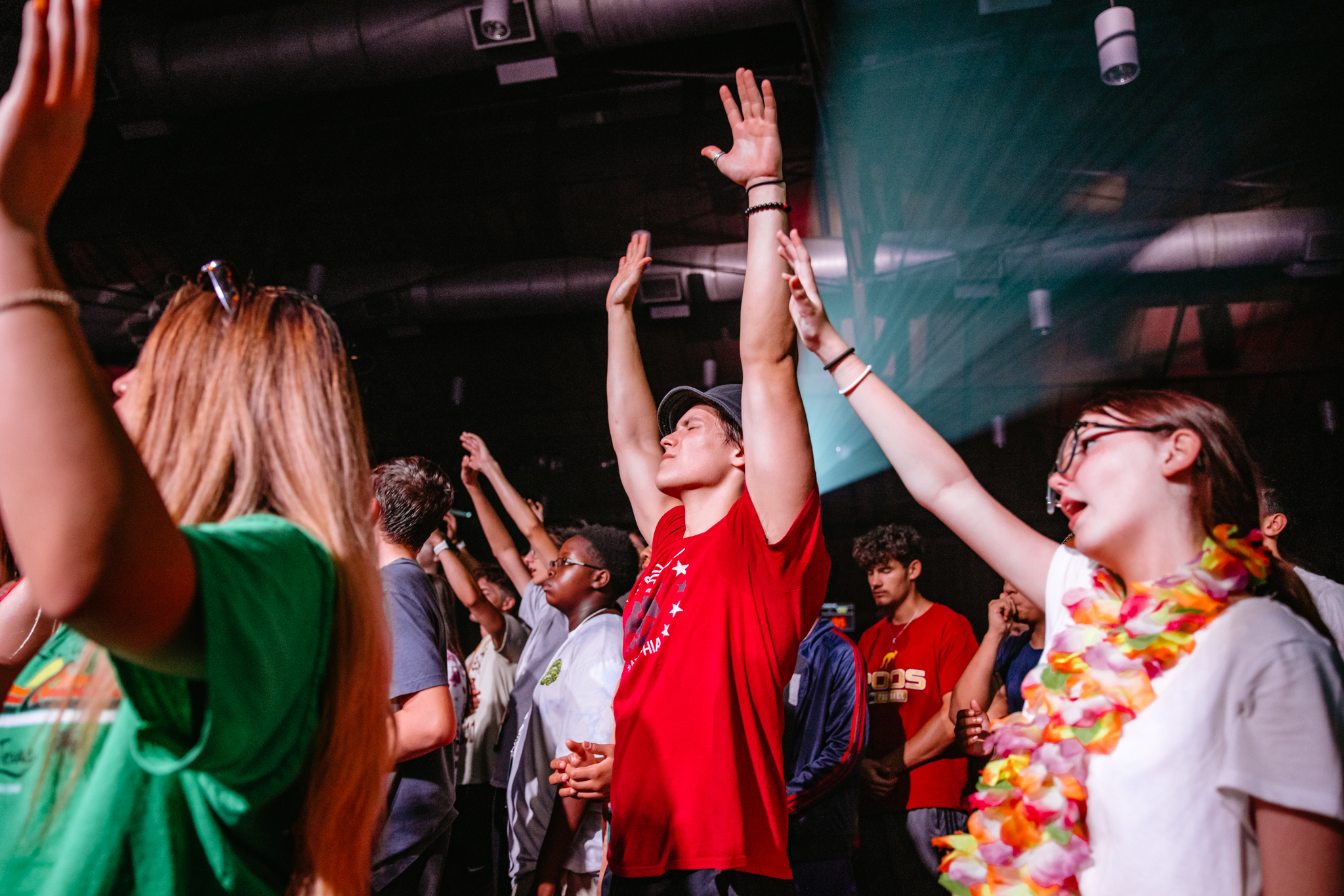 Students worshipping with hands raised