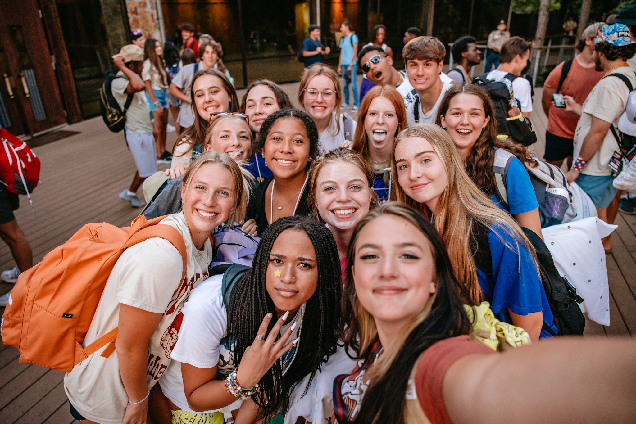 Students smiling together for a group selfie