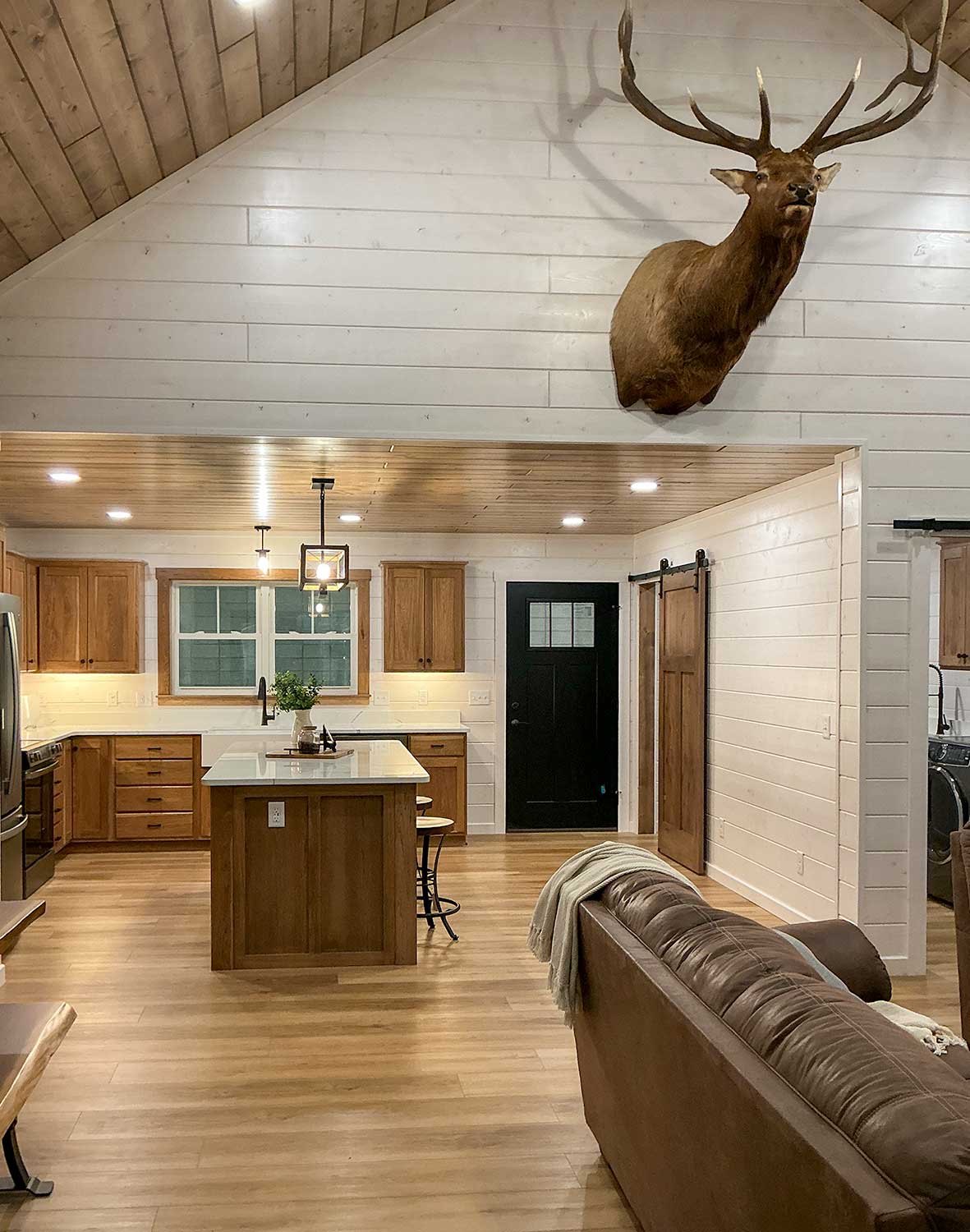 Seamless flow between the living room and kitchen highlights the Grandview's spacious open floor plan, cathedral ceilings, and handcrafted finishes.