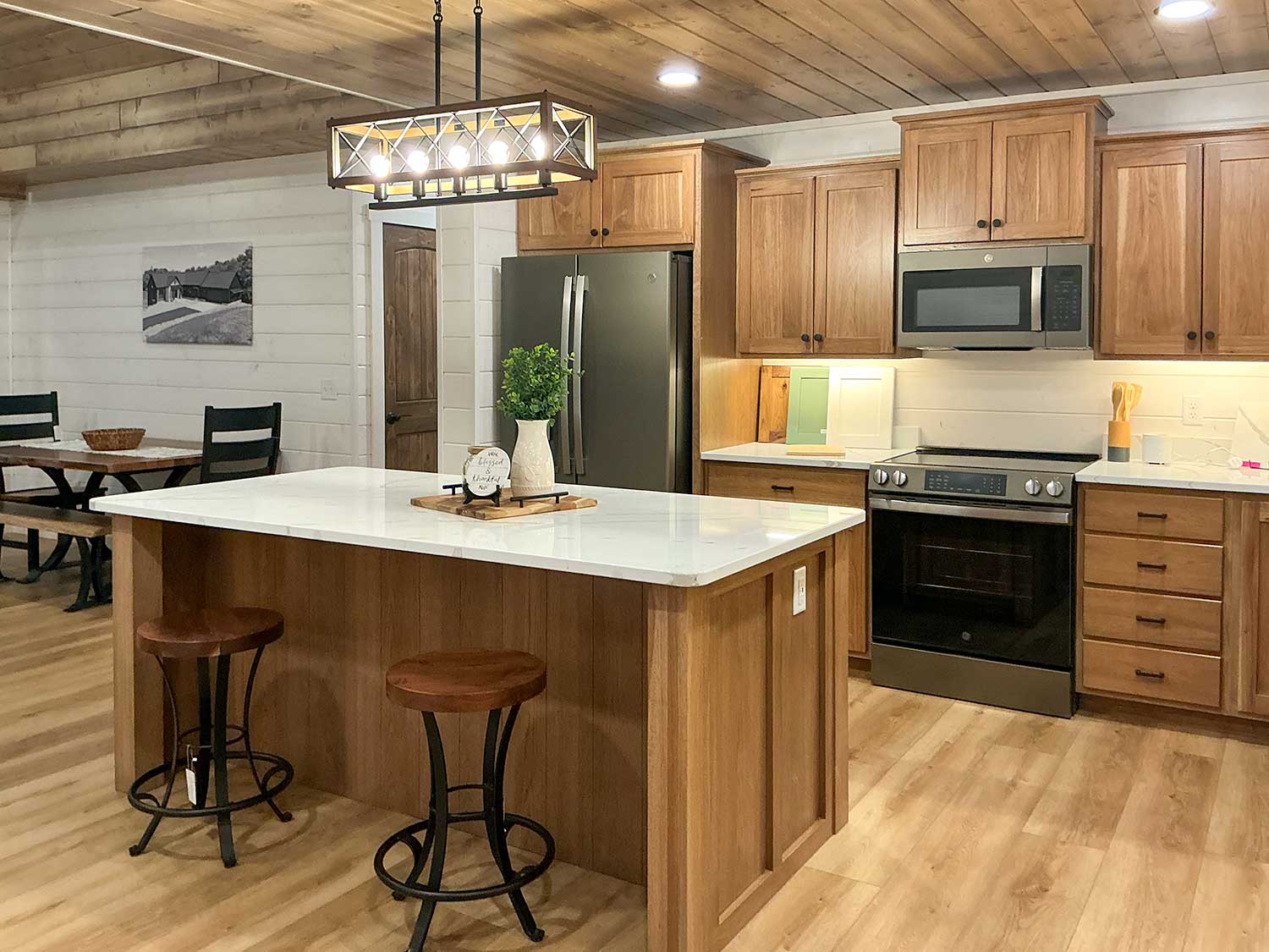 Large center island, custom cabinetry, quartz countertops, and premium finishes provide a functional workspace built for cooking, gathering, and everyday family life.