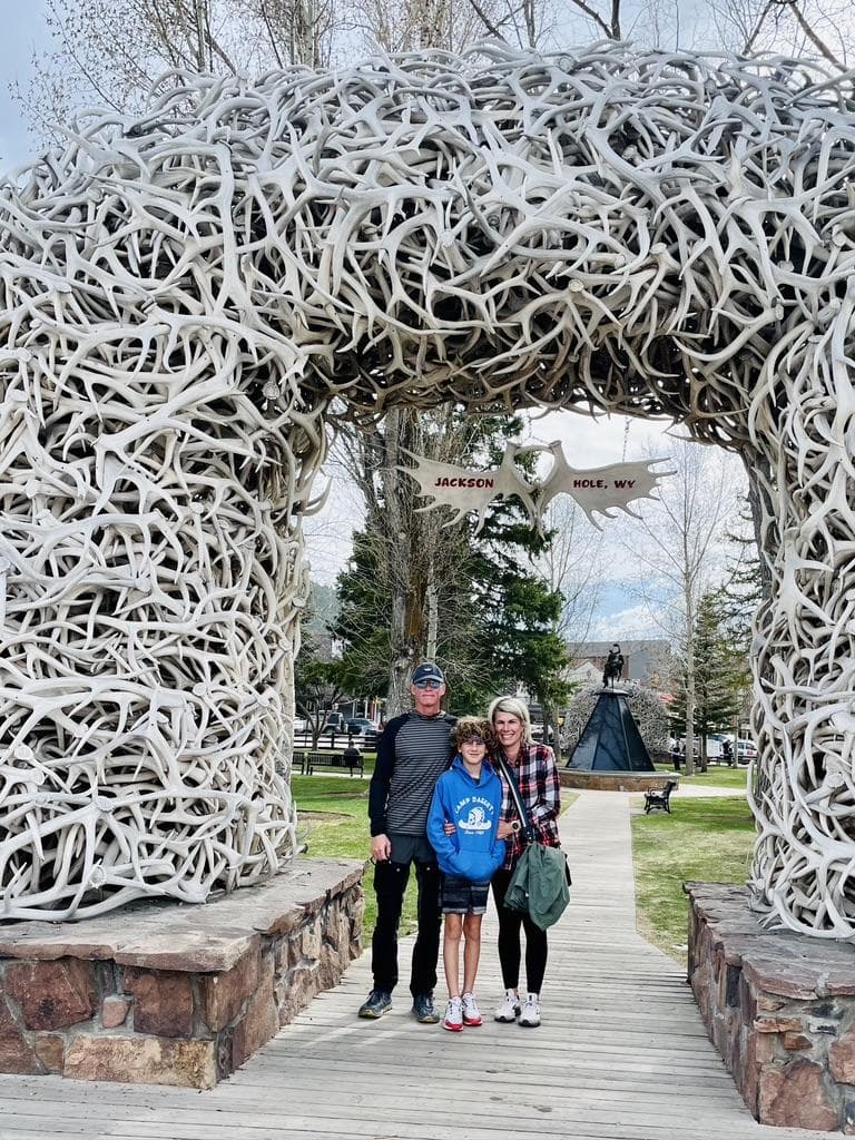 family in front of Jackson Hole Wyoming sign