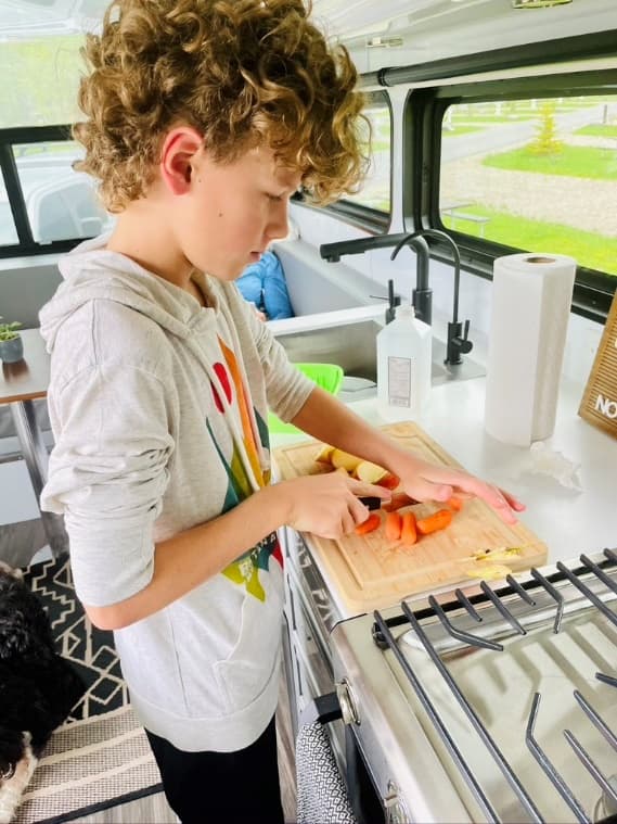 boy cooking in a living vehicle kitchen