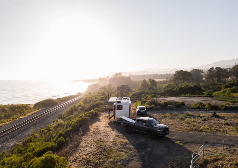 luxury rvs getting towed with sunset
