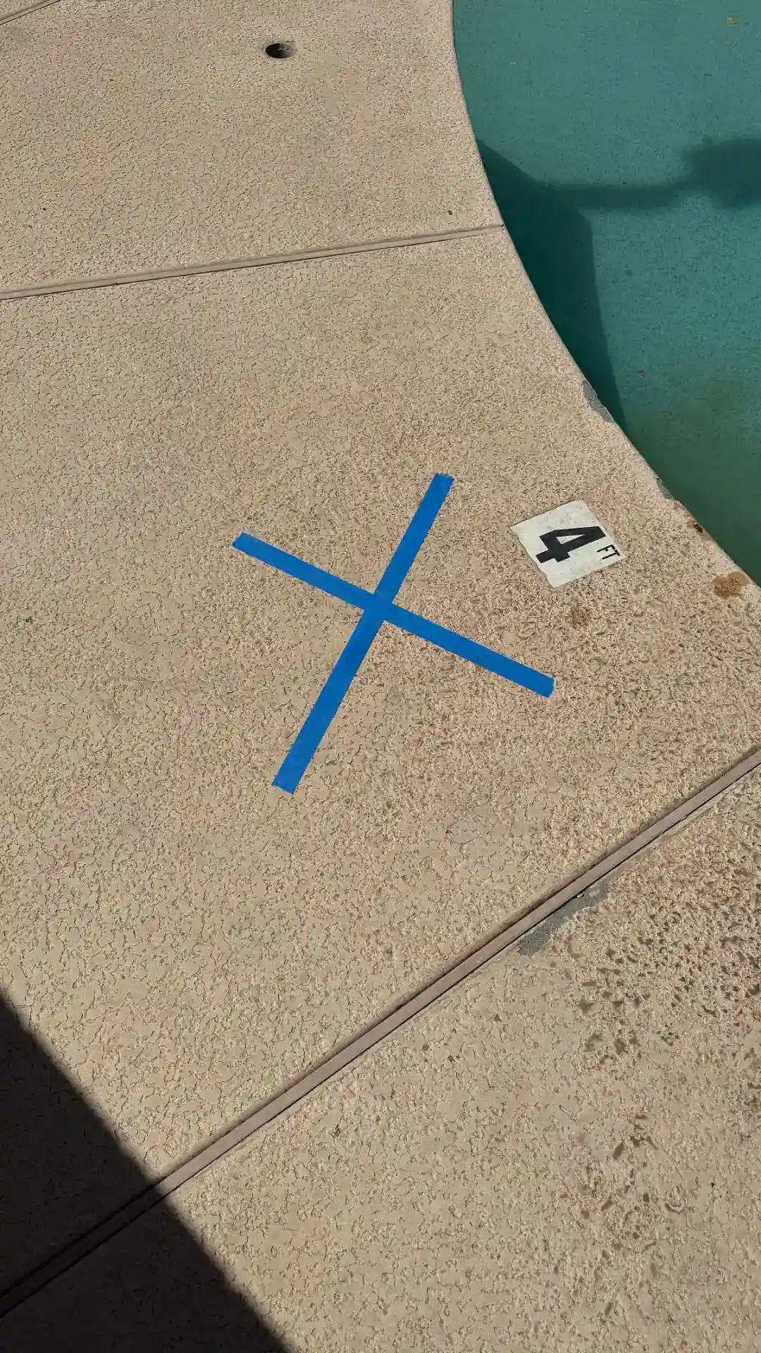 Leak location marked on cool deck above a broken underground return line in Scottsdale, AZ