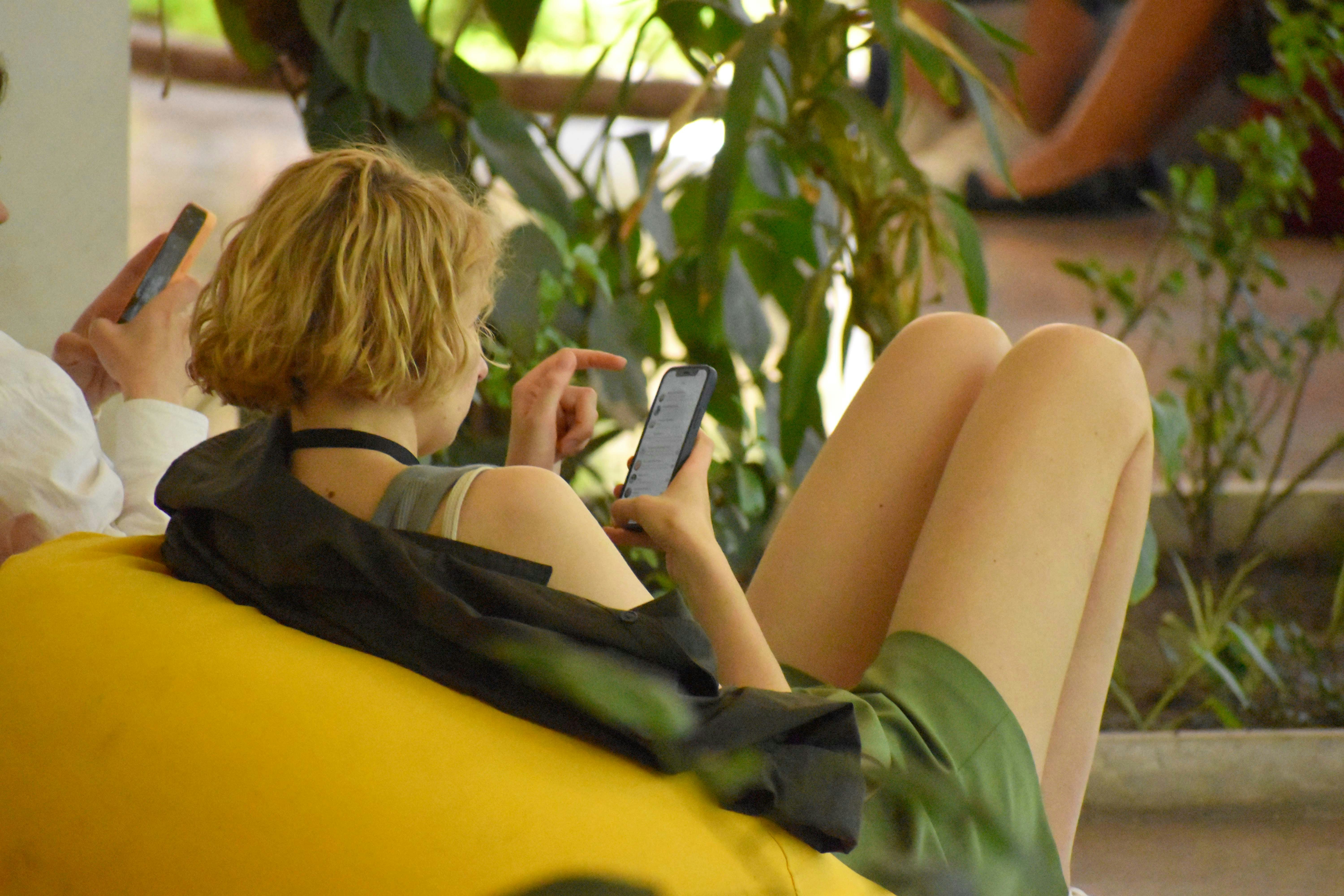 People transfixed to their smart phones in a public setting