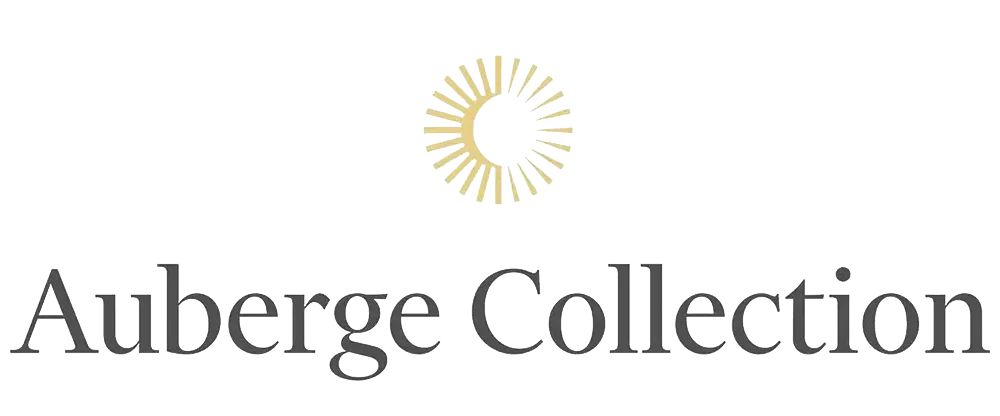 Auberge Collection logo with gold sunburst symbol above black text on white background.