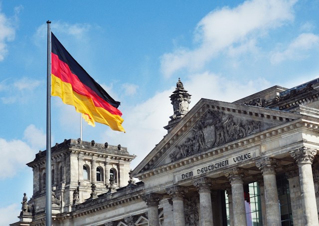 External view of Reichstag building and German flag in Berlin