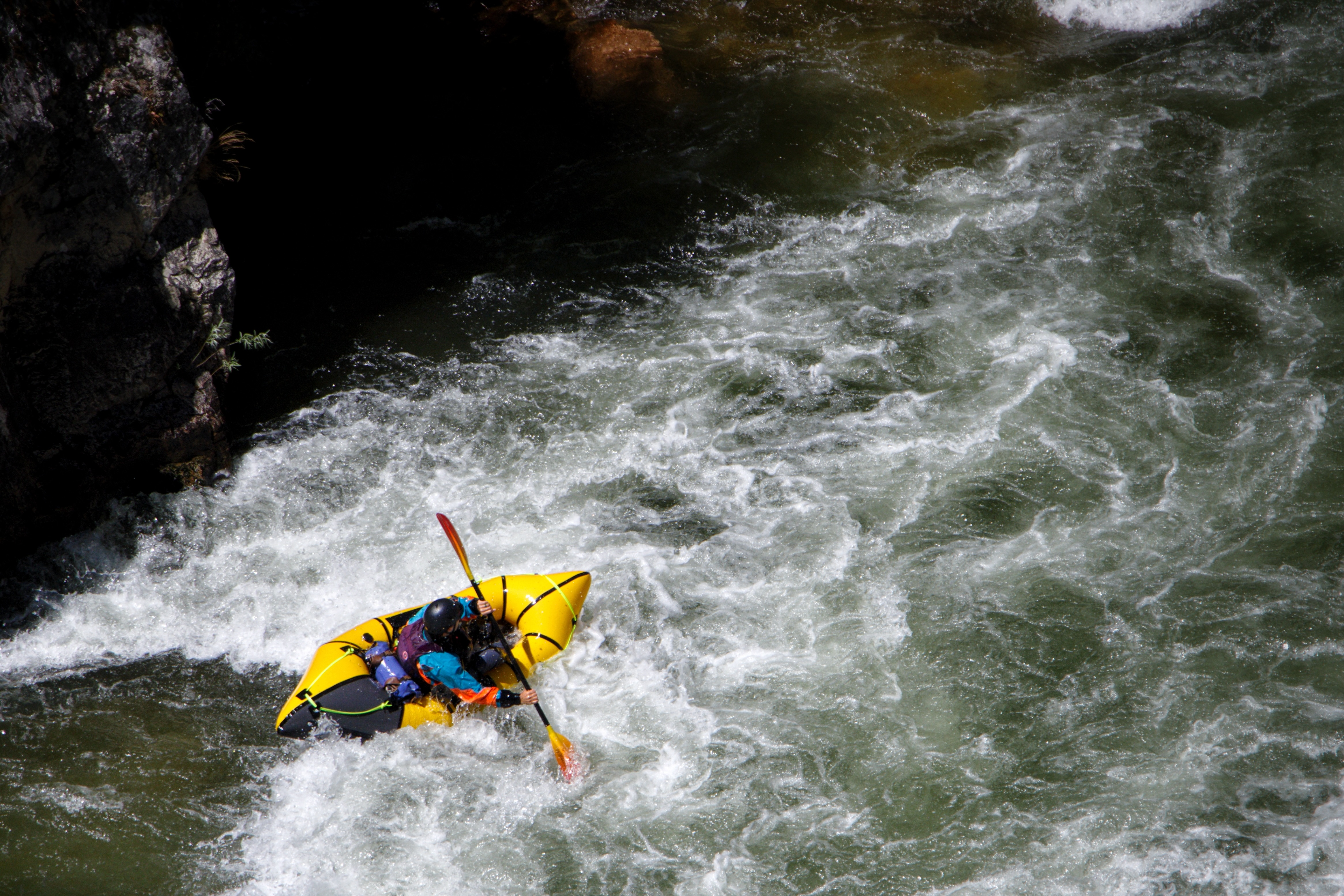 Packrafter paddling whitewater