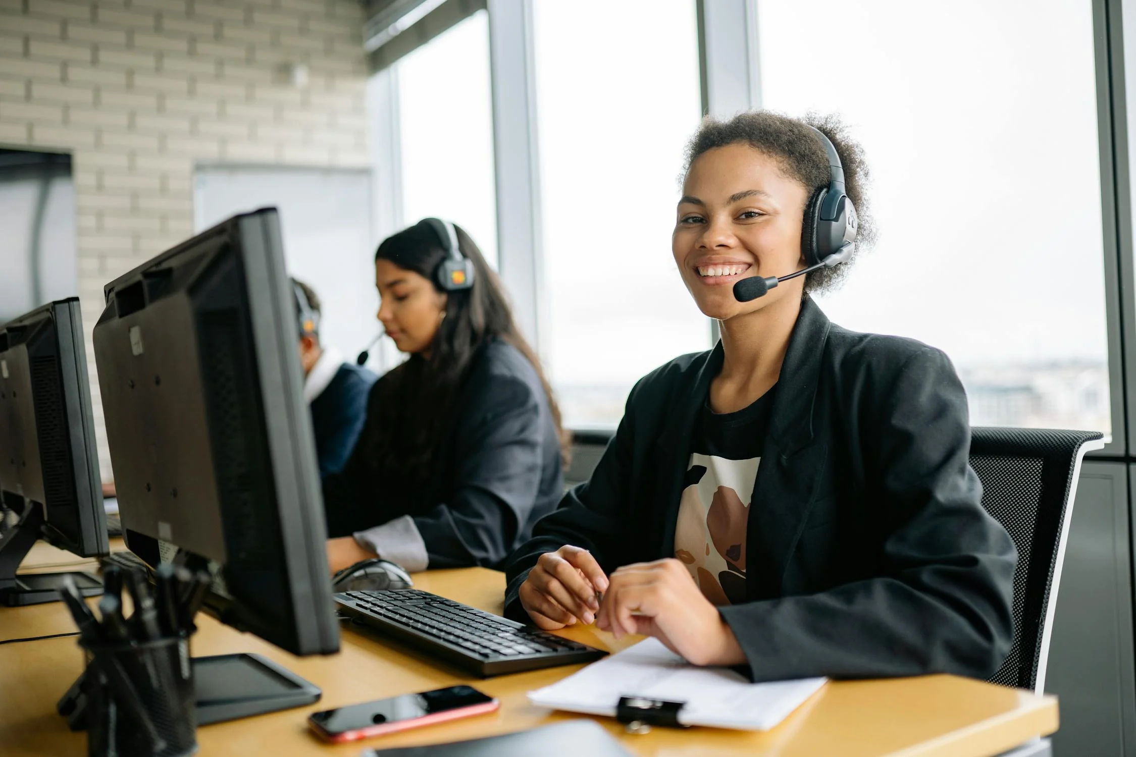 Professional team working in modern call center office with headsets
