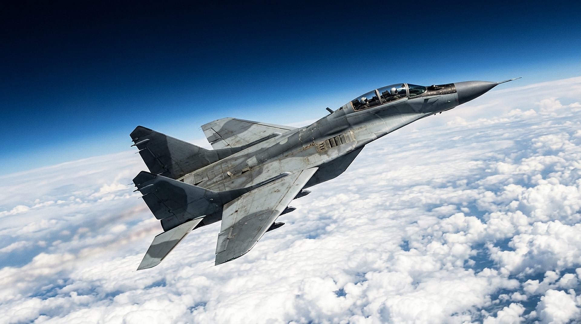 MiG-29UB Fulcrum flying at high altitude above the clouds