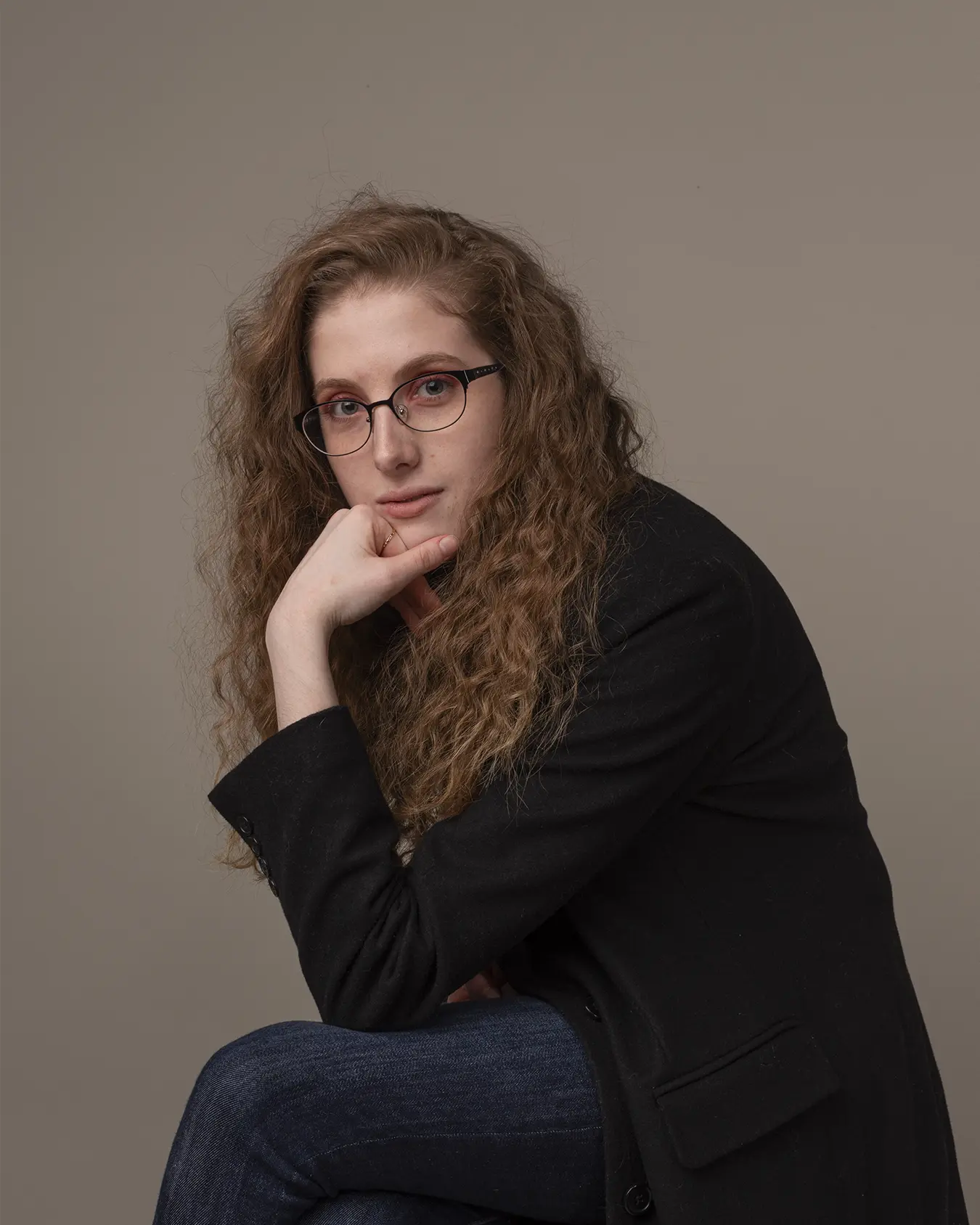 Studio photo of Victoria B. on a grey backdrop.