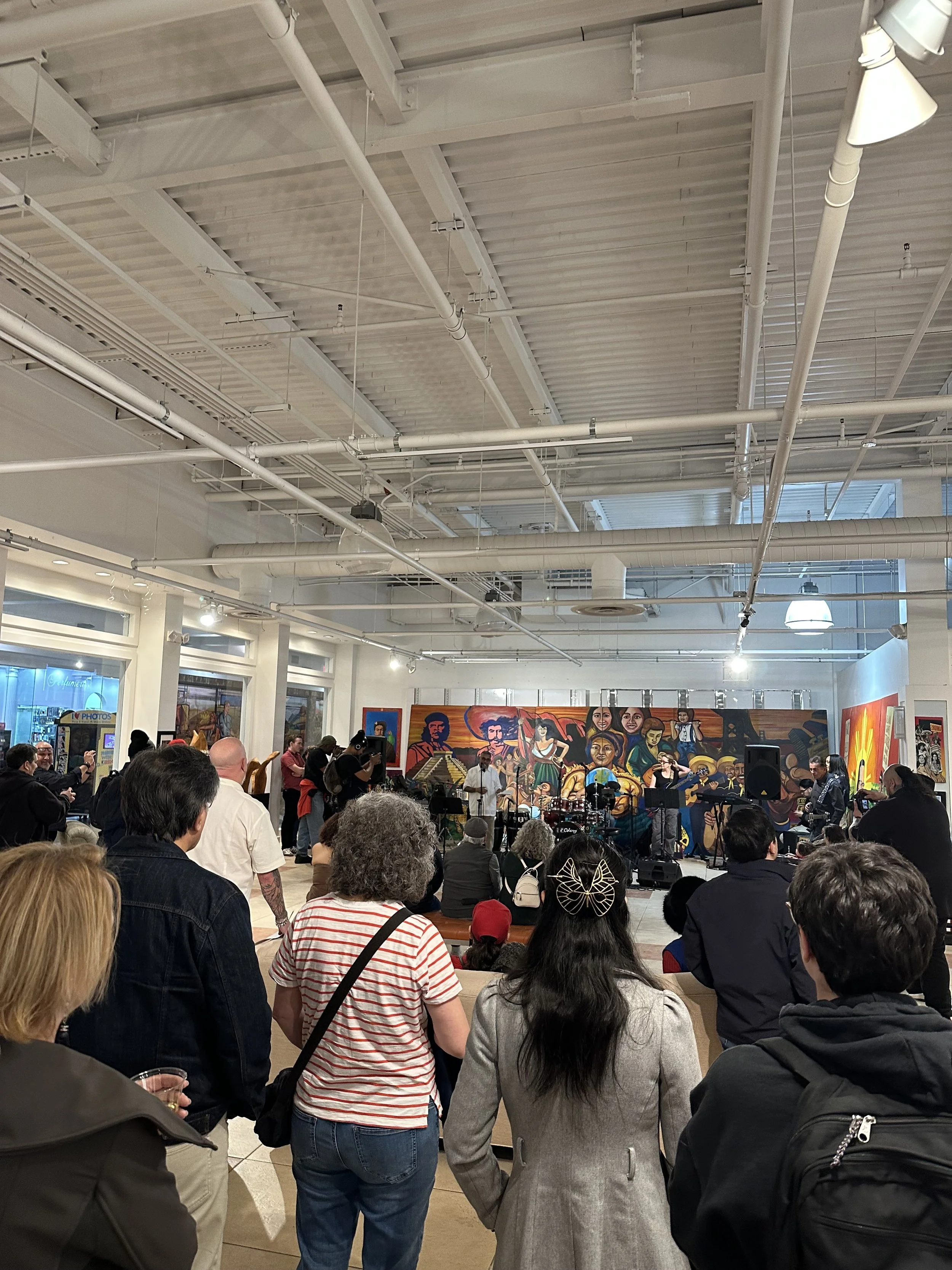 Visitors gather in a spacious art gallery.