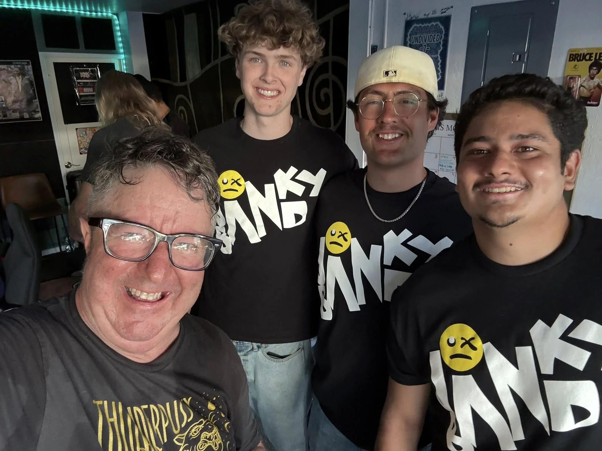 Band members and guests smile for a selfie.