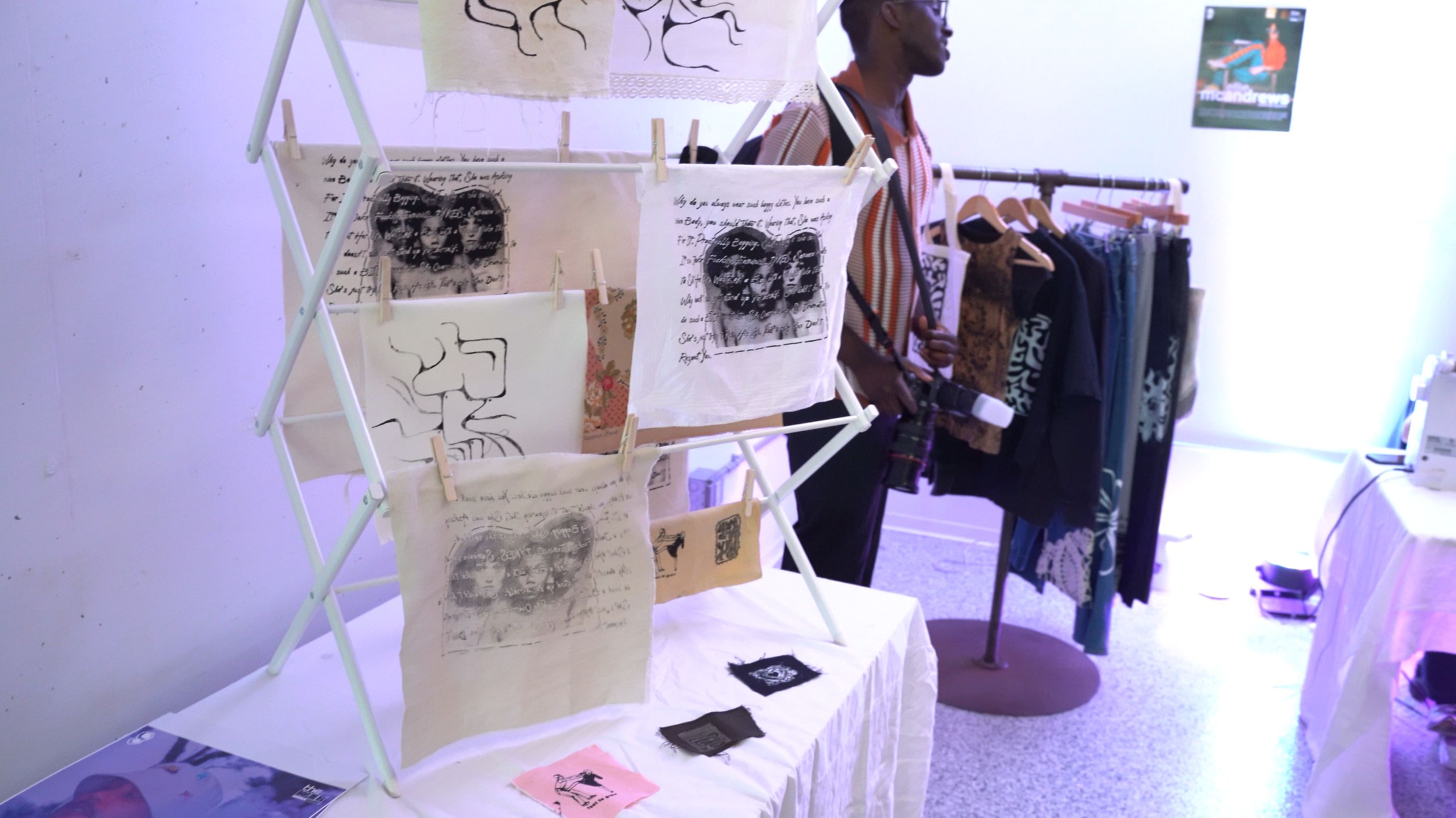 Printed shirts displayed on a rack at the exhibition.