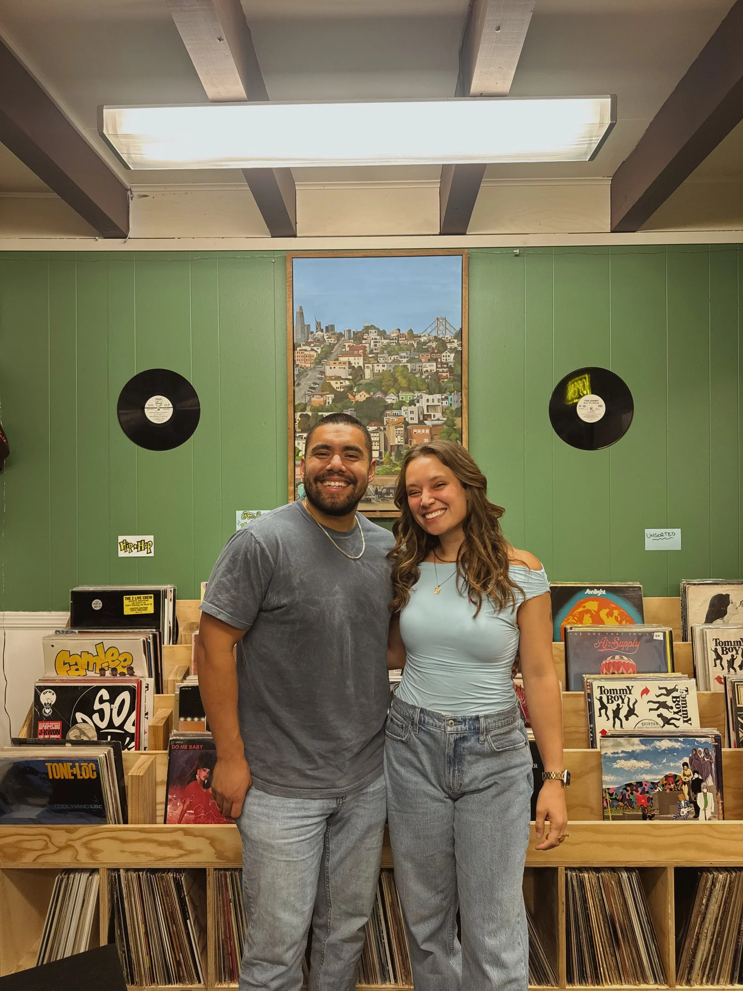 Two participants posing in front of bookshelves.