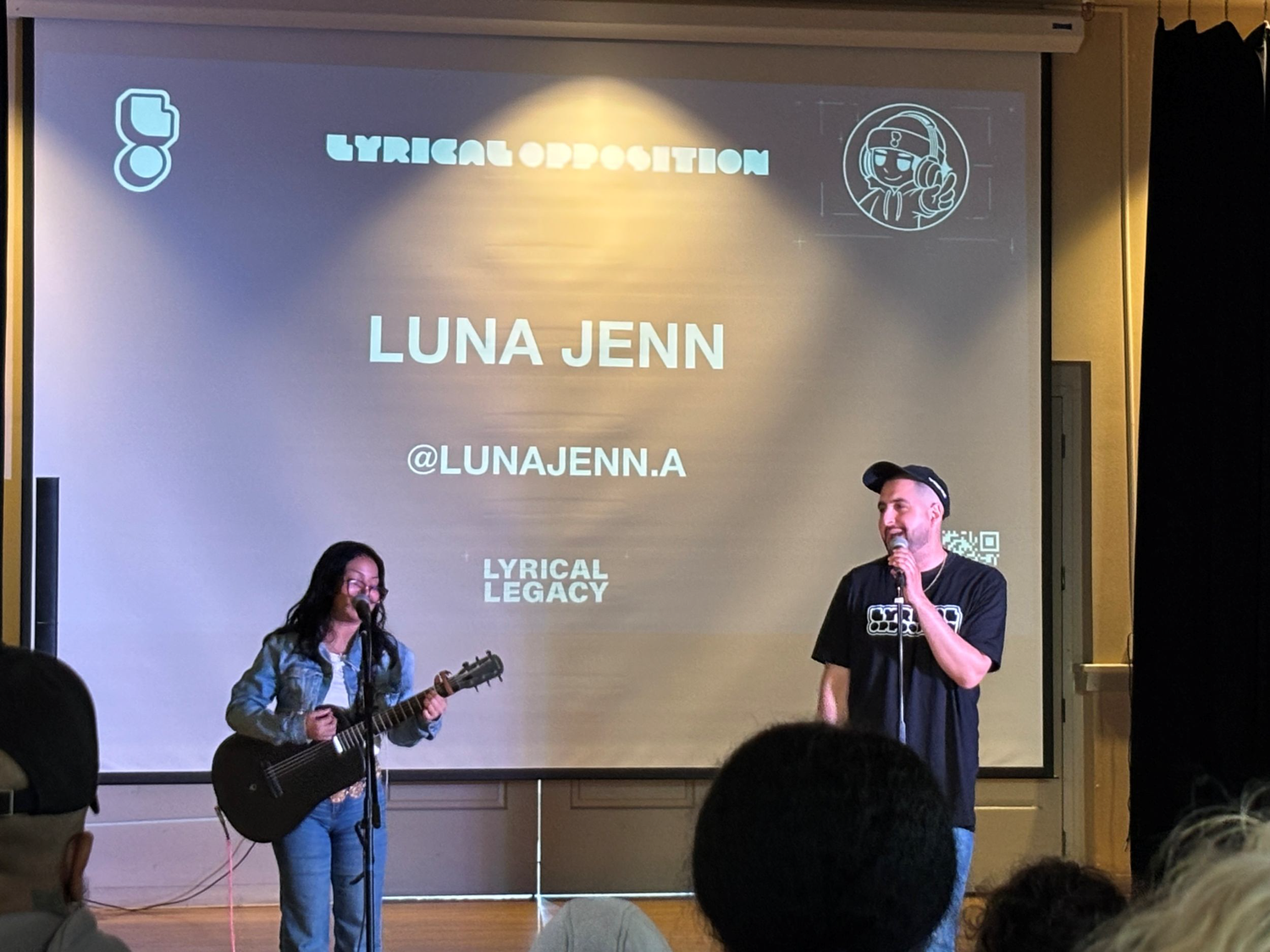 Luna Jenn performs beside an acoustic guitarist.
