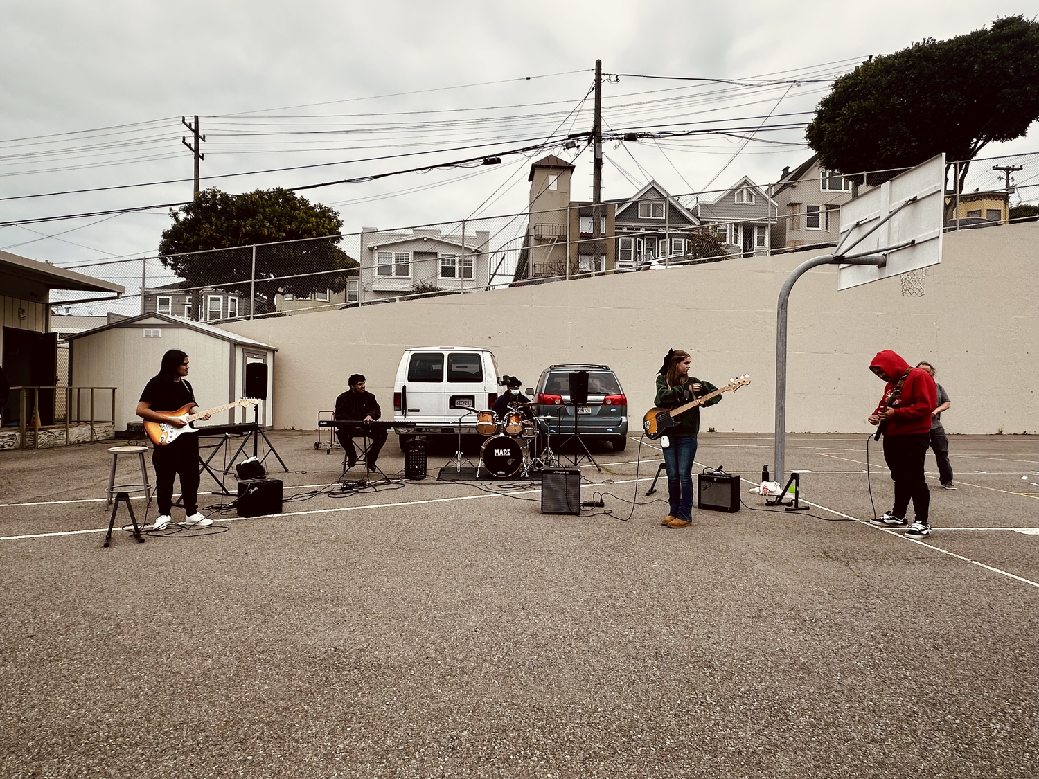 Musicians perform across an outdoor courtyard.