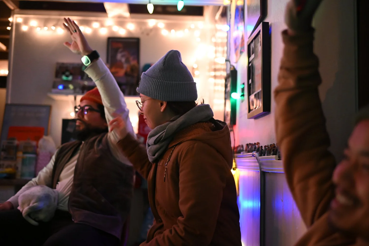 A seated participant raises a hand.