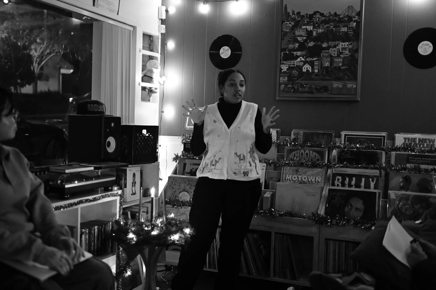 Black-and-white photograph of a participant leading a reading.