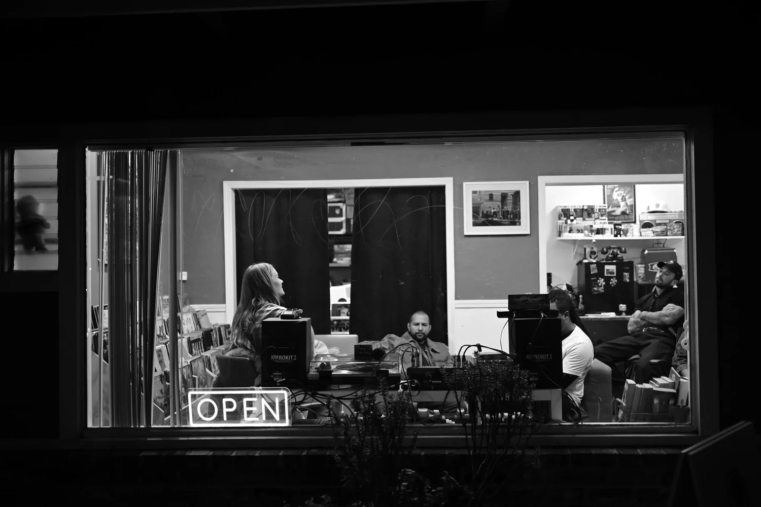 Black-and-white view through the venue window during a performance.