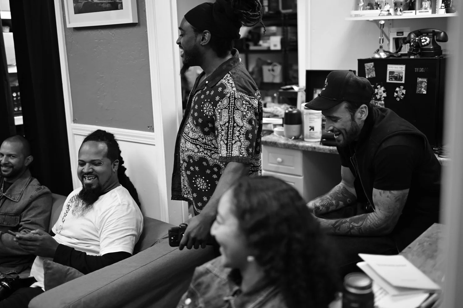 Black-and-white view of smiling participants during a performance.