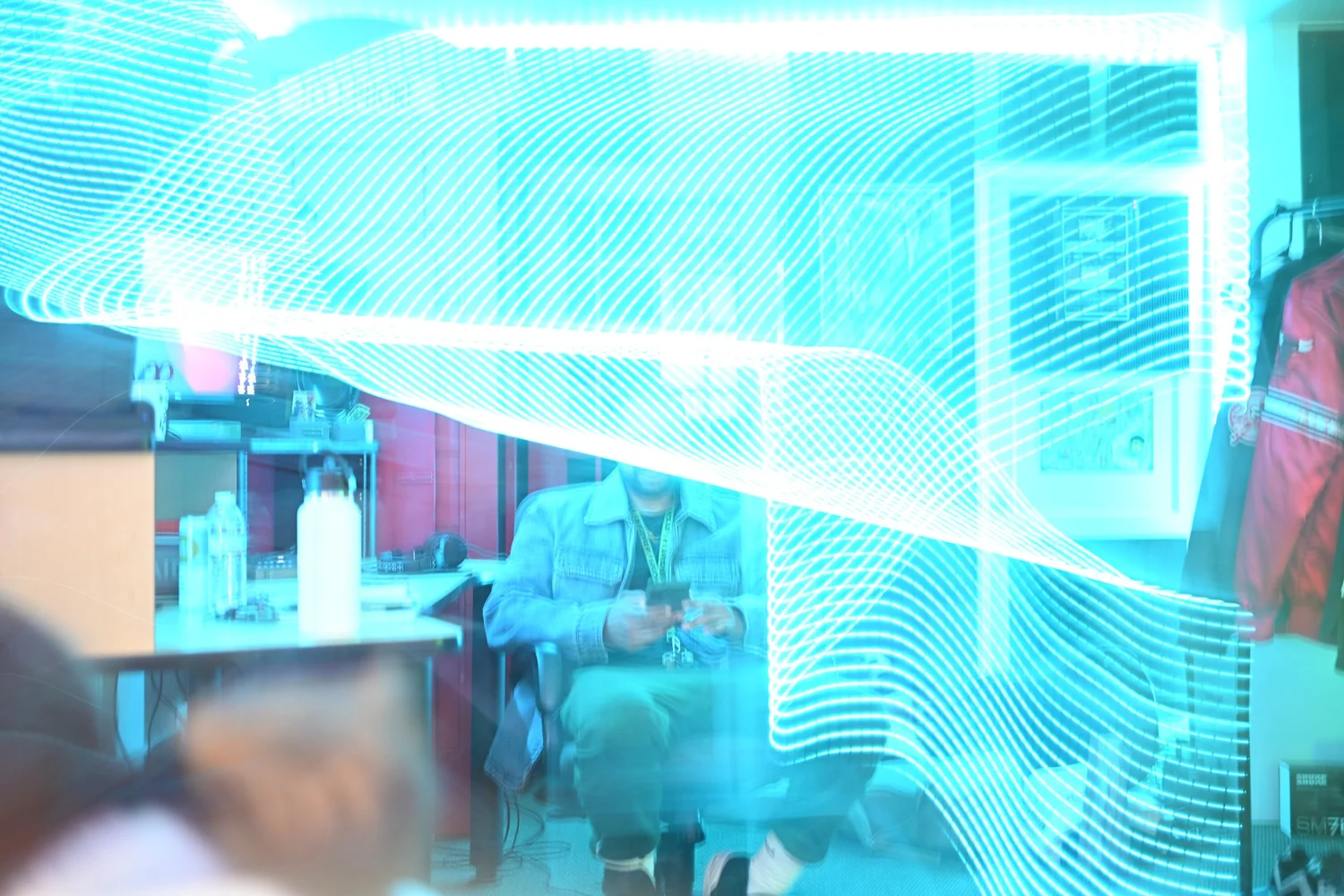 Blue light patterns reflected across the venue window.