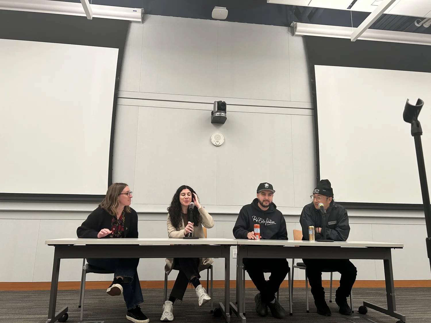 Four panelists discuss the documentary from behind a table.