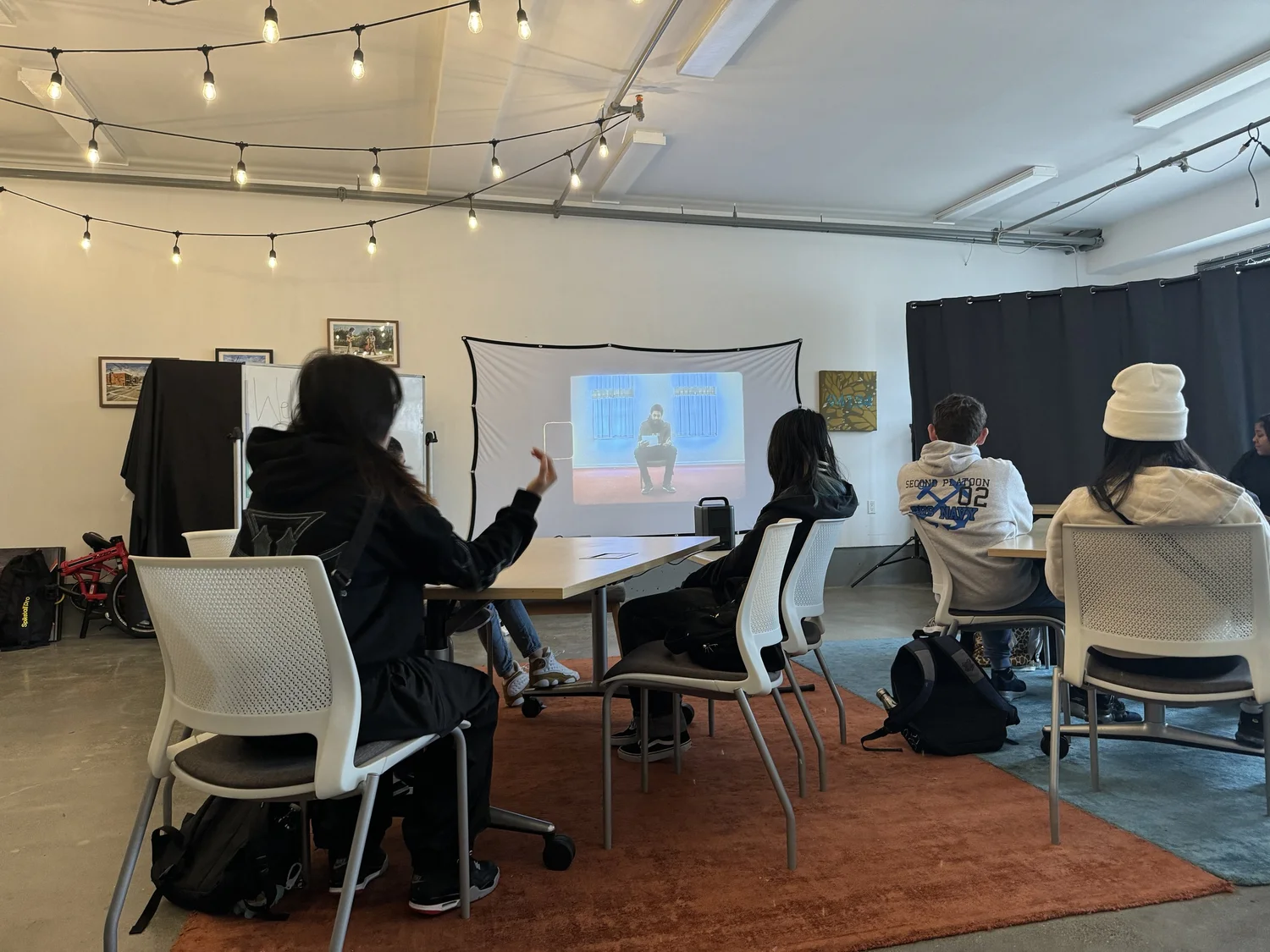 Students watch a projected presentation.