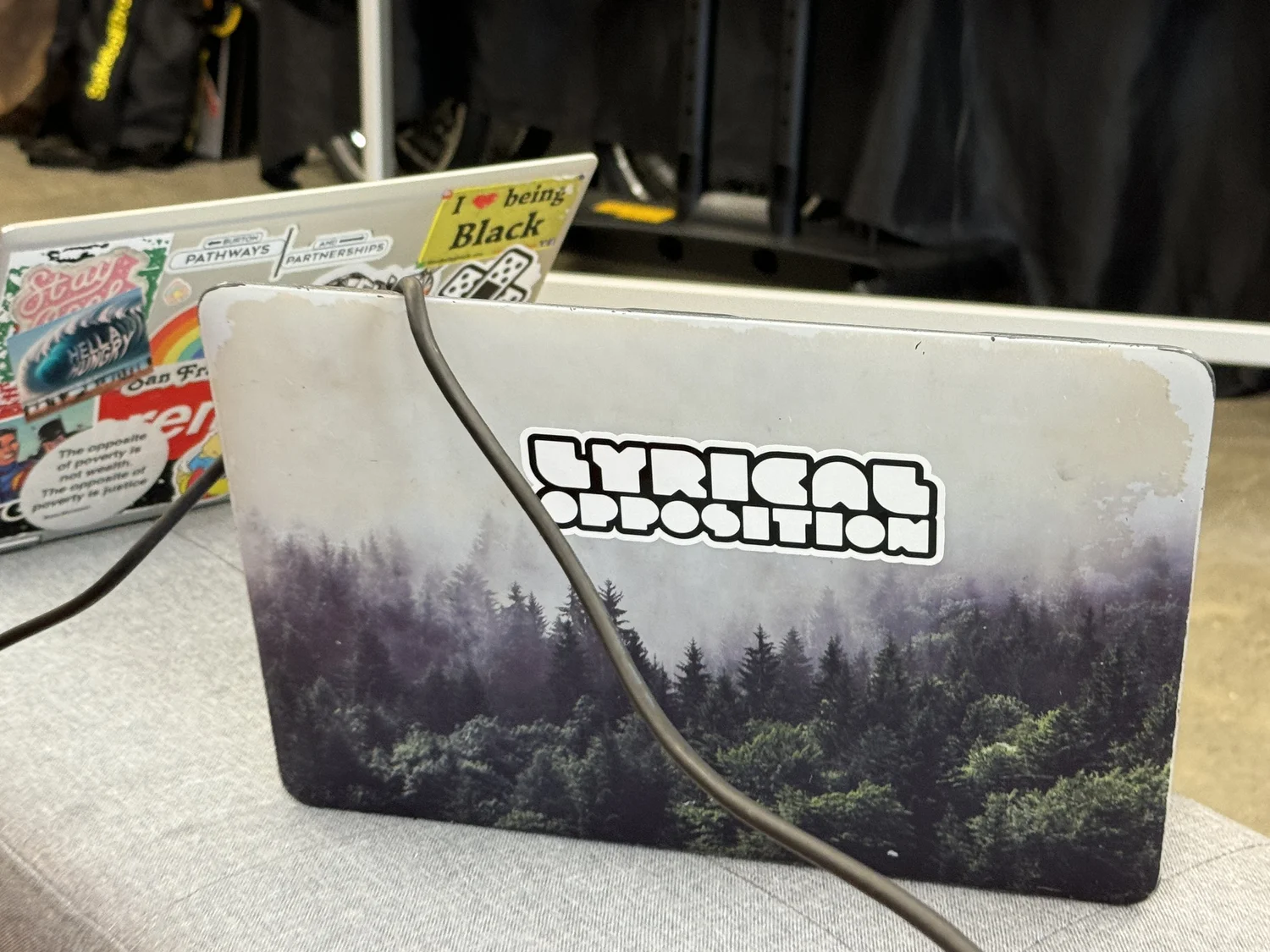 A laptop decorated with a Lyrical Opposition sticker.