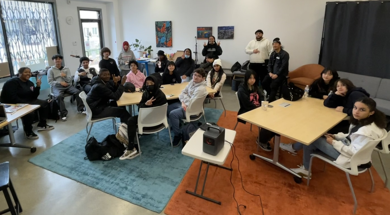 Students gather around tables in the gallery.