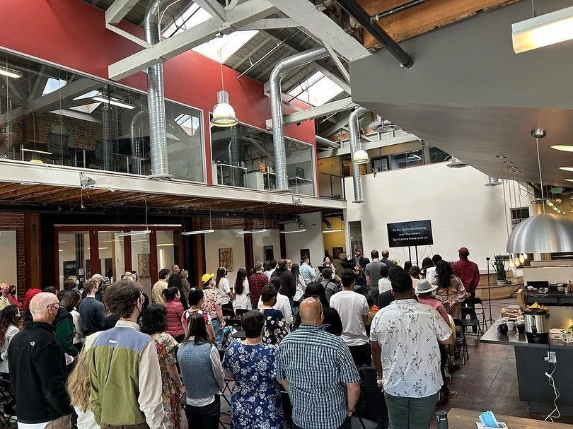 Attendees standing together in the atrium.