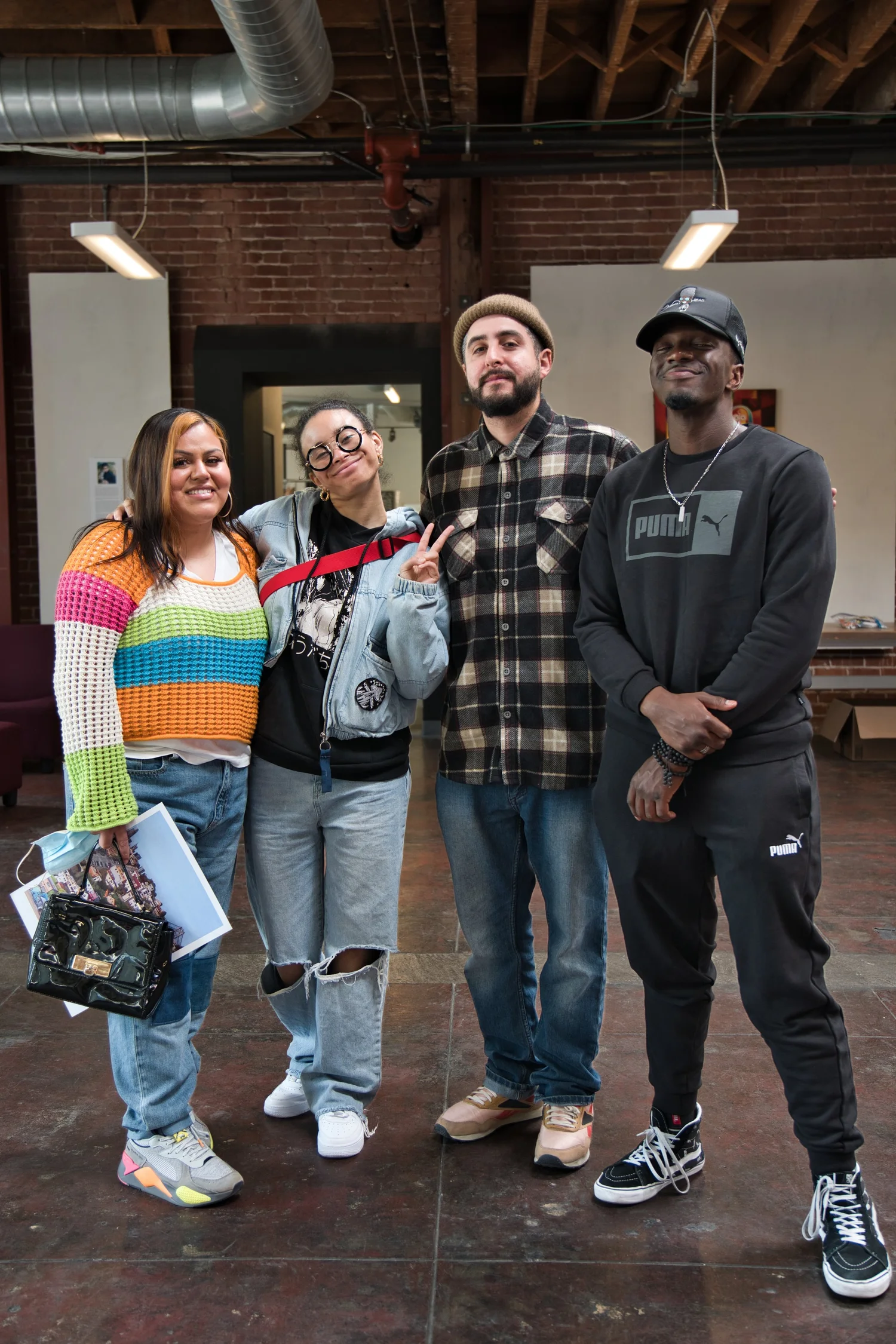 Full-length group portrait of four participants.