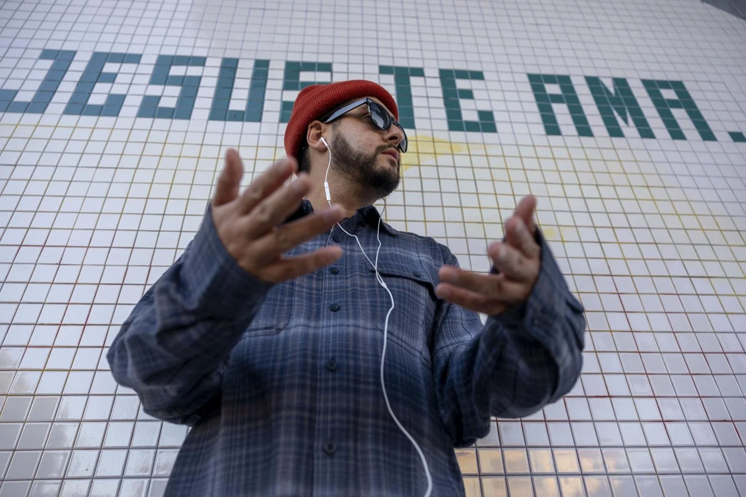 Fego stands outside the Church El Templo De La Fe Asamblea on Valencia St. in the Mission District. He said it brings back childhood nostalgia. “It’s just a good reminder that Jesus loves me,” said Fego. ( Emily Curiel / Xpress Magazine )