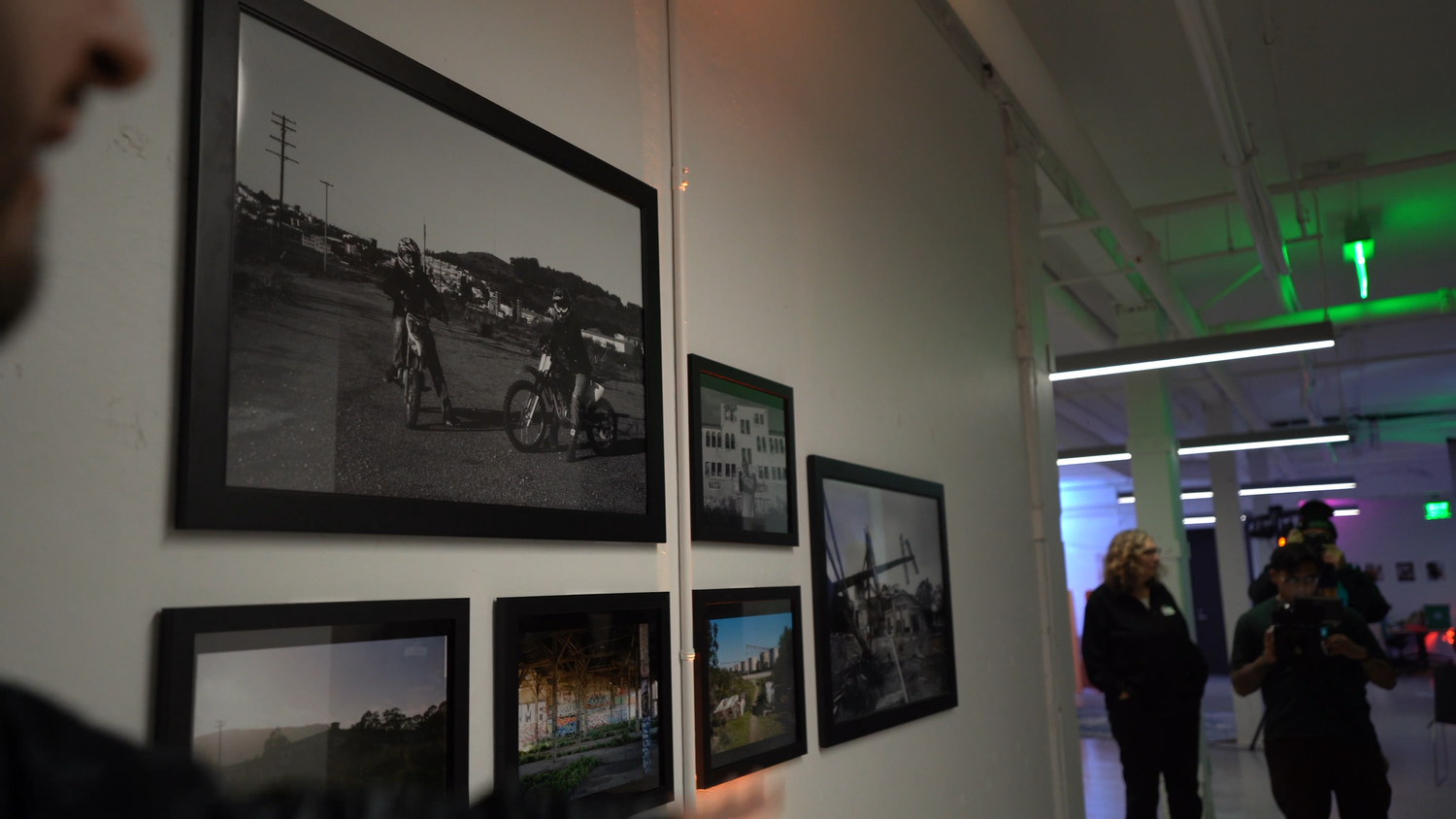 Framed photographs displayed along a gallery wall.