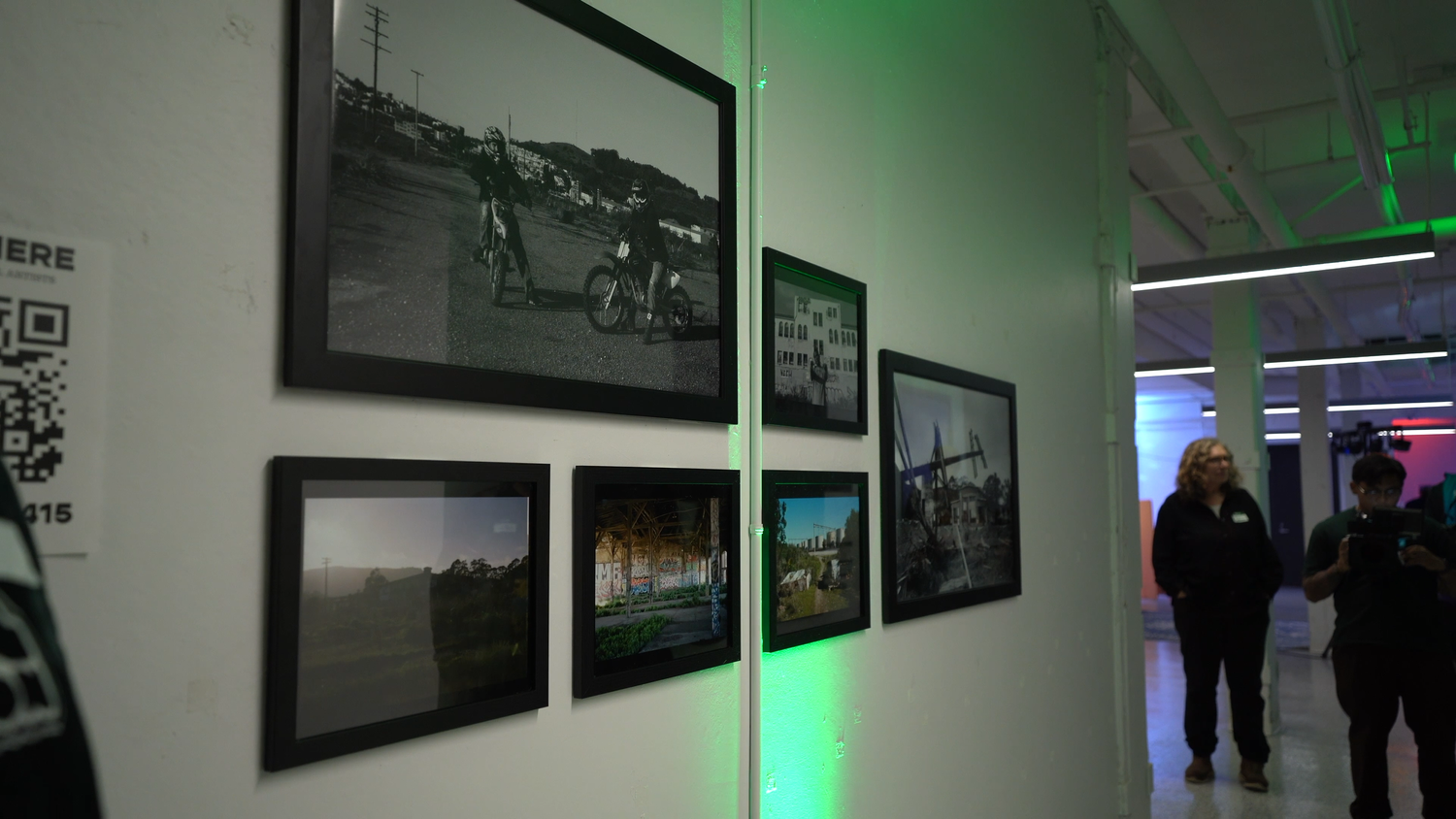 Photographic prints displayed beside the gallery entrance.