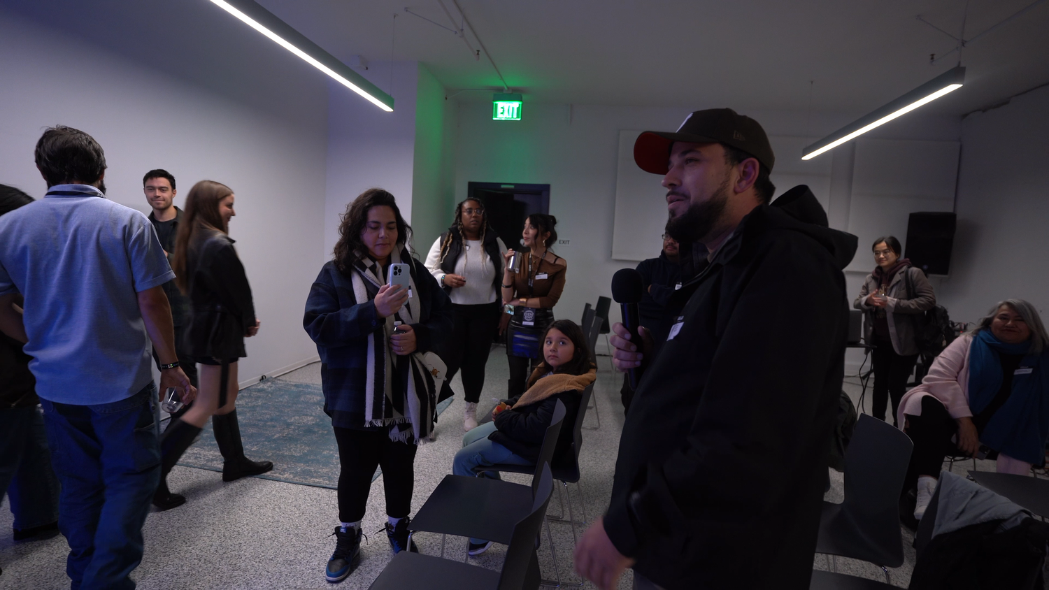 Visitors talk together in the exhibition space.
