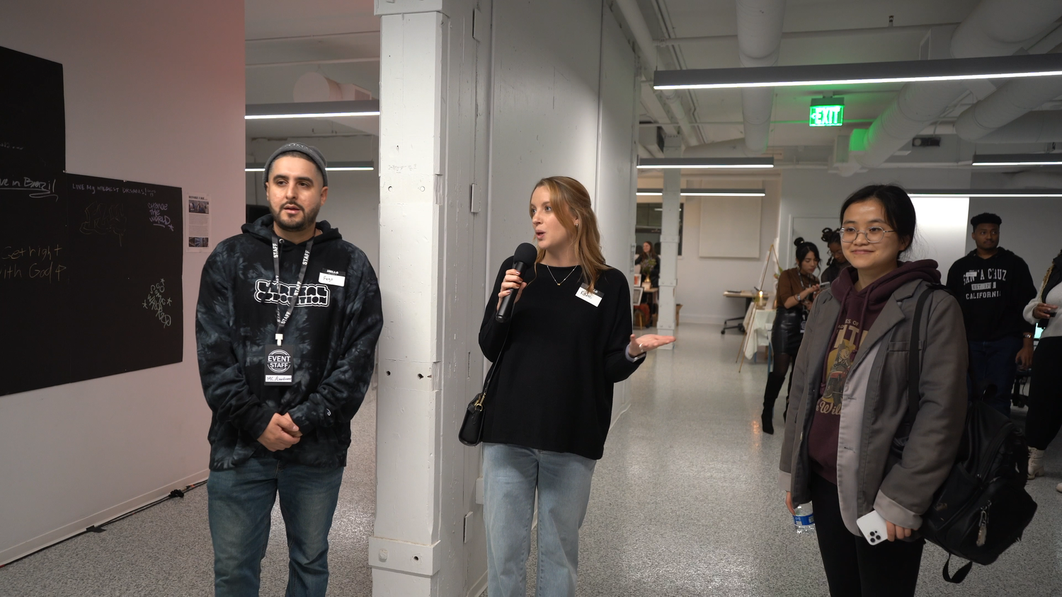 A speaker addresses visitors with a handheld microphone.