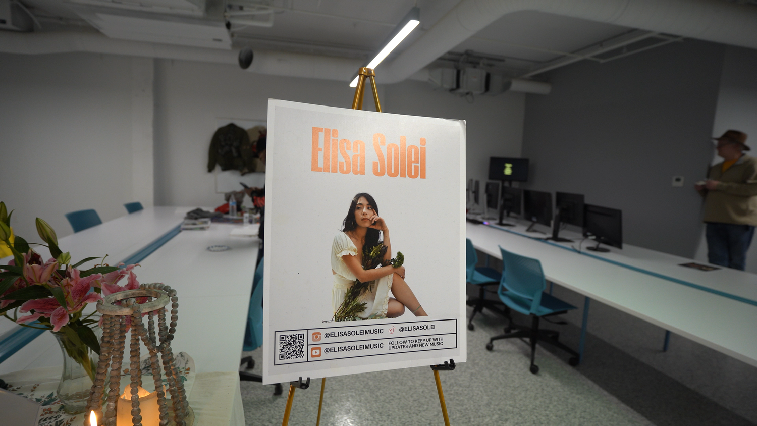 An Elisa Solei performance poster on an easel.